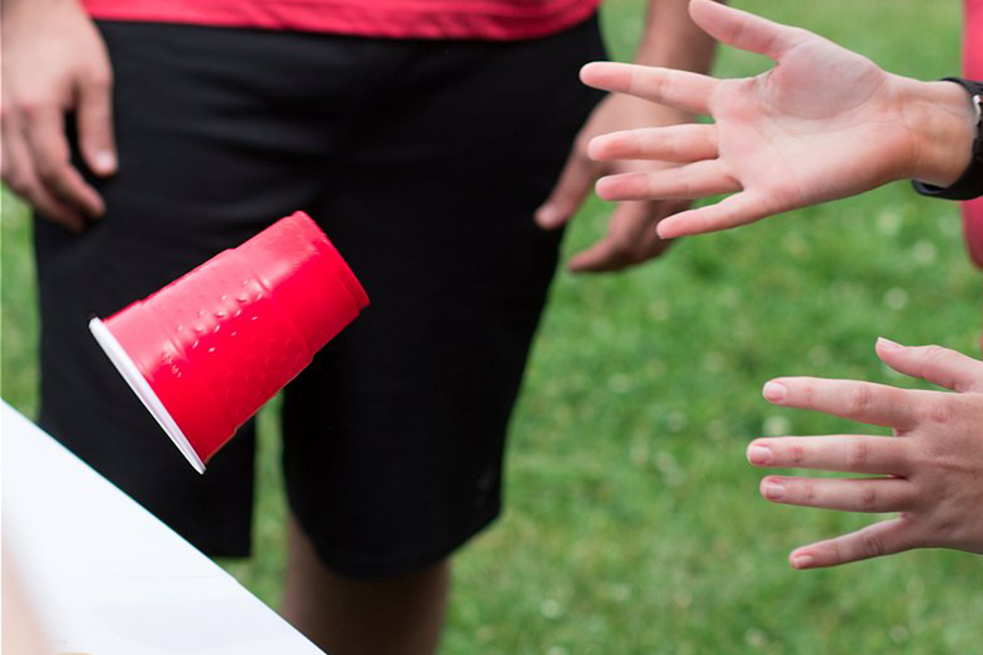 A red solo cup being flipped for the Flip Cup event.